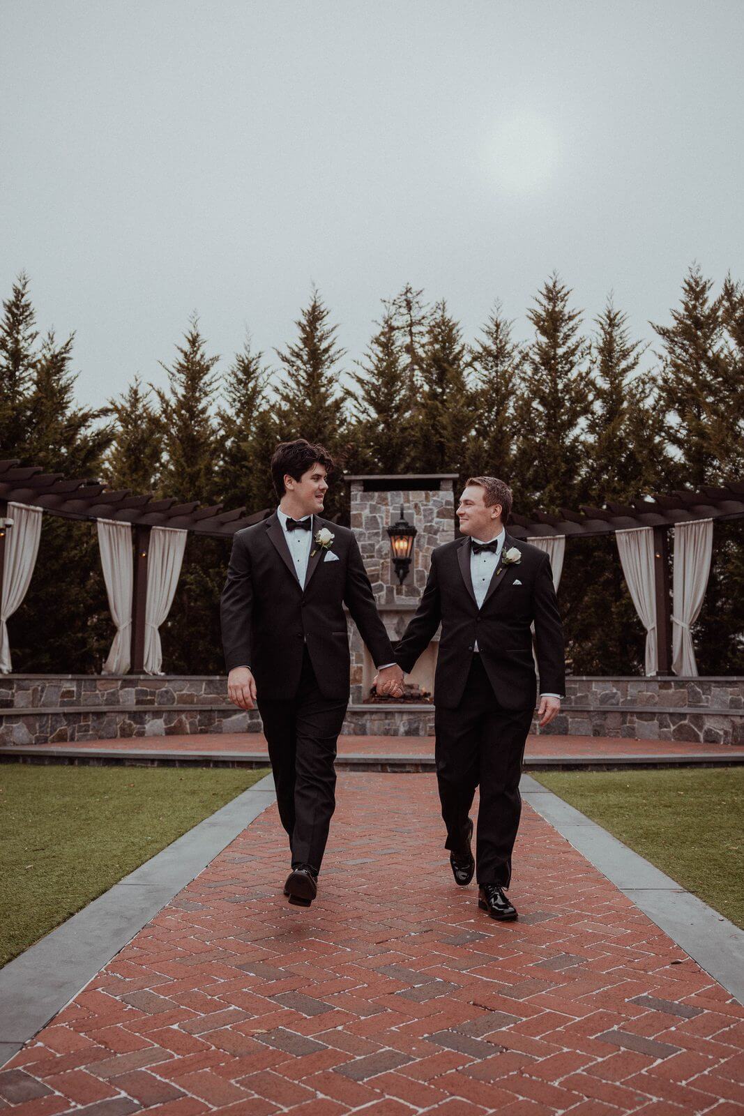 Two grooms holding hands at their New Jersey wedding, photographed by Michael Taramona Productions